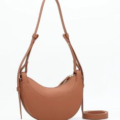 Embrace the epitome of sophistication with our Luna Leather Hobo Handbag. Meticulously crafted from premium genuine leather, this exquisite accessory boasts a sleek half-moon design that exudes timeless allure. Its attention to detail and superior craftsmanship ensure a level of refinement that elevates any ensemble. Whether you choose to drape it over your shoulder or elegantly tuck it under your arm, this versatile handbag effortlessly transitions from casual outings to special occasions. Make a bold statement with the understated glamour of the Luna Leather Hobo Handbag, a symbol of timeless elegance. Chic Smooth Grain Saddle Shoulder Bag, Chic Brown Saddle Bag With Smooth Grain, Chic Brown Smooth Grain Saddle Bag, Understated Glamour, Leather Hobo Handbags, Hobo Handbag, Women Shoulder Bag, Chic Bags, Underarm Bag