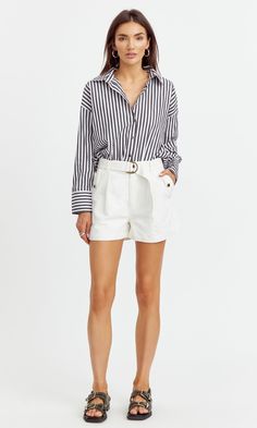 The oversized blouse that's not to oversized. This cotton blouse has a loose fit but keeps the perfect length. Wear with jeans to look effortless or tuck into some shorts for casual outings. Blouse Long sleeve Cuffed Button front Striped Self: 100% Cotton Length: 27 1/2" Chest: 22 1/2" Hand wash in cold water. Lay flat to dry. Low iron. Model is wearing a size small Style #: G241T6930 Casual Short Spring Shirt, Casual Short Shirt For Spring, Chic Oversized Cotton Blouse, Trendy Loose Cotton Shorts, Casual Short Blouse For Day Out, Oversized Cotton Blouse For Day Out, Chic Relaxed Fit Cotton Shirt, Chic Short Cotton Tops, Short Length Cotton Tops For Fall