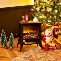 a christmas tree with presents under it and a snowman on the floor next to it