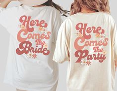 two women wearing t - shirts that say here comes the bride and here comes the party