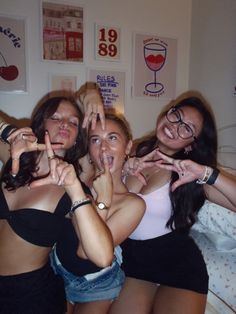 four women posing for the camera with their hands in the shape of two heart signs