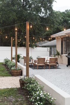 an outdoor patio with string lights and chairs