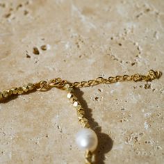 Our Saylor Pearl Choker is the perfect beach babe accessory! What do we love about it? It's neutral and goes with everything! You'll be able to wear this choker all year round and stack it with your favorite coordinating pieces! CHOKER FEATURES Genuine baroque freshwater pearl (5-6mm x 7mm) Yellow Gold, Rose Gold-Plated or Silver Hex Spacer Beads 14K Gold Filled, Rose Gold Filled or Sterling Silver Chain Extender All Necklace Findings (clasp, chain, jump rings) are all Gold-Filled or Sterling Si Chic Adjustable Necklaces For Beach, Festival Gold Necklace With Pearl Chain, Gold Pearl Chain Necklace For Festivals, Festival Gold Pearl Chain Necklace, Elegant Gold Choker For The Beach, Gold Elegant Choker For Beach, Elegant Gold Choker For Beach, Minimalist Pearl Charm Choker Jewelry, Gold Pearl Charm Choker For Wedding