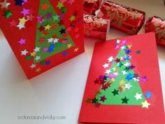 christmas tree made out of red paper with stars on it and candy in the background