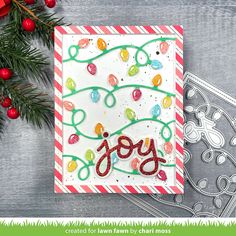 a handmade christmas card with the word joy in red, white and green on it