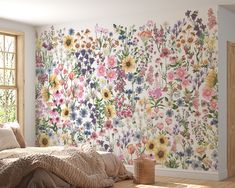 a bedroom with flowers painted on the wall and wooden flooring, next to a window