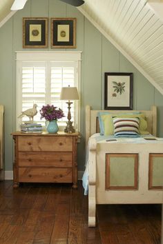 an image of a bedroom with green walls and wood flooring on the bottom level