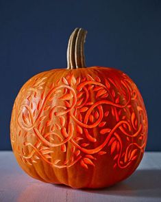 an orange carved pumpkin sitting on top of a table