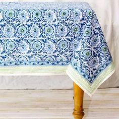 a blue and white table cloth on a wooden chair