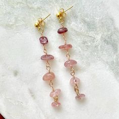 These earrings are handmade with strawberry quartz chip beads, gold toned German style wire, and 18k gold plated earring studs *Because this jewelry is made of natural gemstones, please allow for small variations in gemstone size, color, and texture. However, every effort will be made to have the product accurately match the image shown on the listing Shipping Information ---------------------- This jewelry is made to order. Please allow 3-5 business days for your item to be handcrafted.  Orders $35 or greater are eligible for free shipping If you have any questions please feel free to message me. Thank you for visiting my shop! Gold Dangle Earrings With Gemstone Beads, Diy Wire Earrings, Wire Wrapped Chain, Natural Gemstone Jewelry, Handmade Wire Wrapped, Long Dangle Earrings, Strawberry Quartz, Chip Beads, Earring Crafts