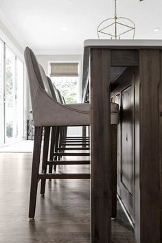 a dining room table and chairs with wooden floors