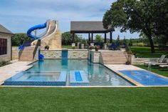 a backyard with a swimming pool and slide