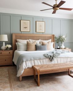 a bedroom with a bed, dressers and ceiling fan in the middle of it