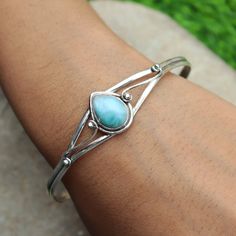 "Dolphin Larimar Bangle, Open Cuff Bangle, Charm Bangle, Amazing Bangle, Sterling Silver Bangle, Natural Larimar, Gemstone Bangle, Gift Her** Metal :- 925 Sterling Silver Style : Bangle Gemstone:-Larimar  Benefits Of Larimar  In the late 1990s, practitioners of feng shui began to promote ammolite as an \"influential\" stone with what they believe is the power to enhance well-being and detoxify the body by improving its flow of energy or \"chi\". Occasion : Birthday Events, Lovely Valentine's Day Gift, Anniversary Gift, Weeding Gift, Engagement Ring, Lover Gift Ring, Hen Party And Other Occasion.... Your order will be handmade and ready for shipment in 1 to 1 business days Normally we ship via UPS it takes 3 to 4 weeks if you need faster delivery You can select Shipping in your cart." Turquoise Larimar Bracelets As A Gift, Larimar Bracelet Jewelry Gift, Handmade Adjustable Larimar Bracelets, Blue Nickel-free Bangle Cuff Bracelet, Larimar Bracelet Cuff, Stone-embedded Bangle Cuff Bracelet For Gift, The Bangles, Gemstone Bangle, Charm Bangle