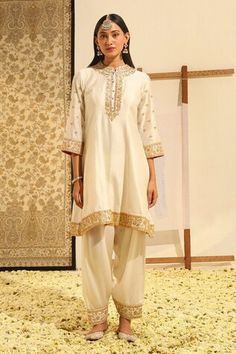 Ivory short kurta with placement floral embroidery using gota patti, dabka, zardozi work. Paired with a salwar with embroidered hem and dupatta with all over geometric pattern and embroidered border. - Aza Fashions White Kurta With Gota Work For Reception, White Silk Set With Gota Work, White Silk Kurta With Mirror Work, Elegant Ceremonial Sets With Gota Work, White Silk Traditional Wear With Mirror Work, White Silk Traditional Wear For Ceremonial Use, White Silk Traditional Wear For Ceremonial Occasions, White Silk Traditional Ceremonial Wear, Zardozi Work