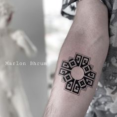 a man's arm with a tattoo on it and the words marron bhrum