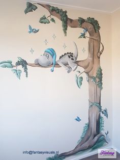 this is an image of a mural in a child's room with animals on the tree