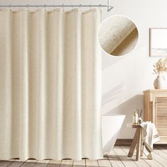 a white shower curtain in a bathroom next to a wooden cabinet and table with a vase on it