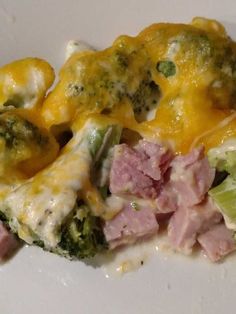 broccoli, ham and cheese casserole on a white plate with melted cheese