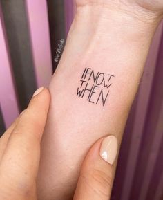 someone is holding their wrist with the word henot when written on it in cursive font