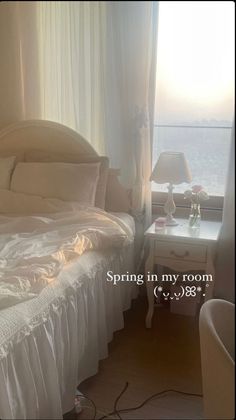 a white bed sitting in a bedroom next to a window with the words spring in my room written on it