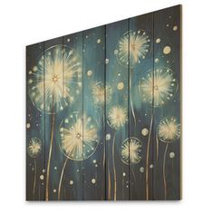 a painting on wood with dandelions painted on it's sides and blue background