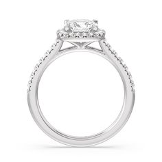 a white gold engagement ring with an oval halo setting and pave set diamonds on the band