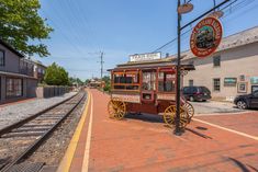 an old fashioned train cart is parked on the tracks