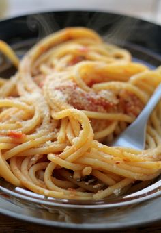 a plate of spaghetti with meat and sauce on it is ready to be eaten by someone