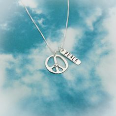 "Peace Heart Necklace, Sterling Silver Peace + Love Necklace, Peace Sign Gift, Peace Love Jewelry, Birthday Jewelry Set, Peace Necklace Gift Unique Peace, Love, & Happiness charm necklace. A sterling silver tag is hammered and hand stamped with \"PEACE\" and paired with a sterling silver peace charm with a little heart in the center. Hangs on a sterling silver chain in the length and style of your choice. Peace charm is 3/4\" in diameter and tag is 3/4\" long. ------------------------------- Sterling Silver Charm Necklace For Birthday, Sterling Silver Charm Necklaces For Birthday, Silver Peace Sign Jewelry Gift, Sterling Silver Charm Necklace For Birthday Gift, Sterling Silver Charm Necklaces For Birthday Gift, Spiritual Peace Sign Necklace As A Gift, Stamped Charm Necklaces For Valentine's Day Gift, Peace Heart, Peace Necklace