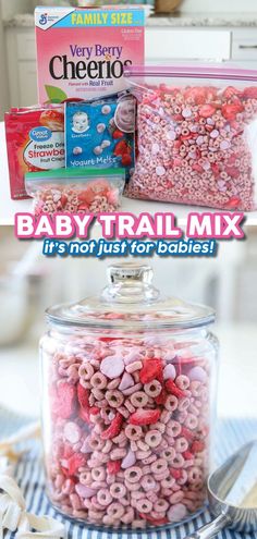 baby trail mix in a glass jar with pink and red cereal inside it, on top of