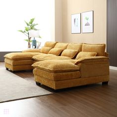 a living room with a large yellow sectional couch