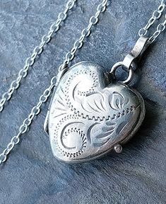 ♥Welcome to RAVEN FALLS ♥ Celtic, Curios, Cats, Trees & Crows  ✯ VINTAGE HEART LOCKET NECKLACE ✯ ✯ Sterling Silver ✯ This is a lovely vintage locket necklace.  The locket is a heart shape with a pretty fauna scroll style pattern on the front. Inside there are red velvet inserts and it opens and closes securely. It is marked for sterling silver on the back and comes suspended on a more modern 18" sterling silver chain also marked 925 for sterling silver. Please check photos  for more details, tha Heart-shaped Sterling Silver Locket Necklace For Anniversary, Heart Shaped Hallmarked Silver Locket Necklace, Vintage Metal Heart Locket Necklace, Vintage Silver Locket Necklace For Valentine’s Day, Vintage Heart-shaped Sterling Silver Locket Necklace, Sterling Silver Locket Necklace, Locket Necklace Vintage, Heart Locket Necklace, Vintage Lockets