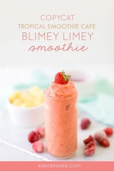 a smoothie in a glass with raspberries on top and the words copycat tropical smoothie cafe blmey limey smoothie