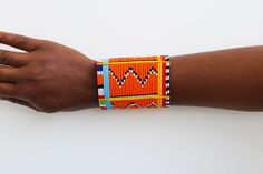 African Maasai beaded bracelets, Maasai Cuff Bracelets, Maasai Wrist bracelets, Beaded bangles, Cuff bracelets, Christmas gift, Moms gift The bracelet is made by the Maasai women in Kenya.  It is beautiful and can compliment any outfit. Available in medium and large size Medium size: fits a standard wrist size of 7.5 inches Large Size: fits a wrist size of 8 to 8.5 inches Shipping fee is for the first item only. Other items ship for FREE! Shipping via DHL Express that takes 3-5 days to be delivered. To view more items from our shop, kindly click here: nkoroicrafts.etsy.com Thank you for visiting! Orange Bracelets As Festival Gifts, Orange Bracelet For Festivals As Gift, Orange Bracelets For Festivals Gift, Orange Festival Bracelet As Gift, Multicolor Cuff Bracelet For Festivals And Gifts, Multicolor Cuff Bracelet As Gift For Festivals, Traditional Beaded Wristband Gift, Traditional Handmade Orange Bracelets, Traditional Multicolor Cuff Bracelet As Gift