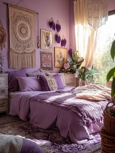 a bedroom with purple walls and lots of pictures hanging on the wall above the bed