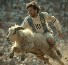 a man riding on the back of a goat in front of an audience at a sporting event