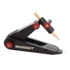 a pair of black and red pencils sitting on top of a stapler