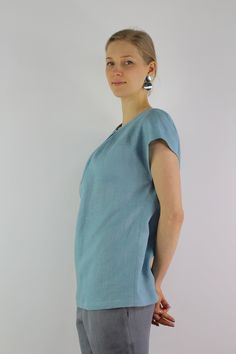 "Handmade turquoise linen blouse with short sleeves, perfect for casual wear and suitable for any occasion in any season Details: - 100% natural linen produced in Europe ; - medium weight (180 gram per square meter); - color: turquoise, can be any from our colors catalog (color samples at the photo); Made to order, approximately a few days, If you have any questions please message me and I will be glad to answer. Size guide : Size XS Bust: fits bust around 33\"-34\"/ 84-88 cm Waist: fits waist a Blue Linen V-neck Blouse, Light Blue Relaxed Fit Linen Tops, Relaxed Fit Light Blue Linen Tops, Casual Turquoise Short Sleeve Blouse, Light Blue Linen Short Sleeve Top, Turquoise Short Sleeve Tops For Spring, Turquoise Short Sleeve Top For Summer, Turquoise Short Sleeve Top With Relaxed Fit, Turquoise Relaxed Fit Short Sleeve Top