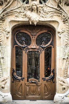 an ornate wooden door with wrought iron work