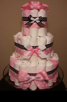 a multi layer diaper cake made to look like it has pink and white polka dots