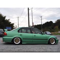 a green car parked in a parking lot