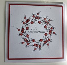 a christmas card with a wreath made out of pomegranates on it