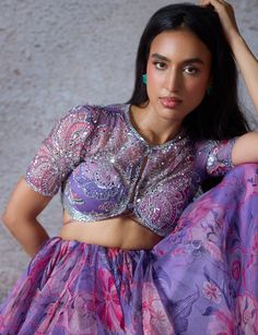 Stand out with the Lilac Printed Organza Lehenga Set, exuding unique charm and elegance. Made from organza fabric, this exquisite lilac lehenga flows gracefully, adorned with a mesmerizing floral print pattern in vibrant hues of pink and purple. Teamed with an intricately embroidered blouse showcases delicate beadwork and sequin embellishments, adding a touch of elegance and sophistication. Completed the look with a beautifully embroidered sheer organza dupatta that drapes effortlessly, featuring matching embroidery for a perfect blend of tradition and contemporary style. Ideal for brides-to-be at Mehendi or Sangeet ceremonies, this outfit promises to make you shine with unparalleled grace. Composition : Lehenga - Organza, Dupatta - Organza, Blouse - Organza Care: Dry Clean Only and Vacuum Lilac Lehenga, Mahima Mahajan, Kurta Lehenga, Lehenga Pattern, Printed Lehenga, Organza Lehenga, Lehenga Skirt, Embroidered Dupatta, Floral Prints Pattern