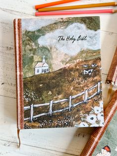 a notebook with the words, the tiny barn on it and two pencils next to it