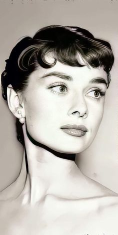 a black and white photo of a woman with short hair