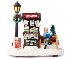 a christmas scene with a boy sitting on a sleigh reading a book in front of a newsstand