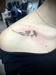 Small tattoo on woman collarbone micro tattoo iris Butterfly And Iris Tattoo, Iris Googoodolls Tattoo, Dainty Iris Tattoo, Iris Tattoo Fine Line, Black And White Iris Tattoo, Iris Goo Goo Dolls Tattoo, Iris Tattoo Goo Goo Dolls, Black Iris Tattoo