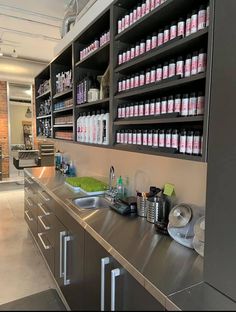 a kitchen with stainless steel counter tops and shelving