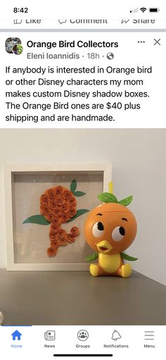 an orange bird is sitting in front of a picture frame with the word orange bird on it